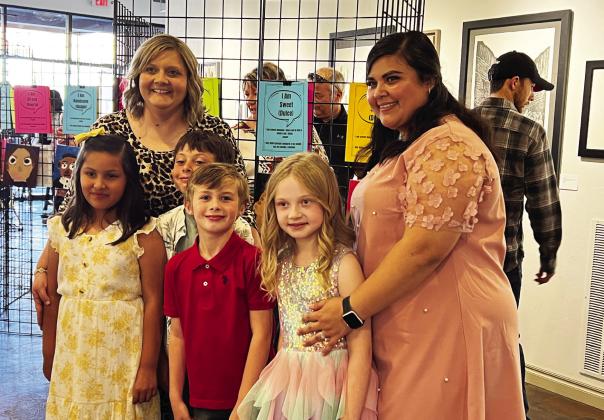 Whitebead first-grade teachers Erica Shippey (back left) and Isamara Prieto (far right) with several of the student artists who showed their self-portraits during Monday night's art show at The Vault Art Place and Gathering Space in downtown Pauls Valley. News Star photo by Suzanne Mackey