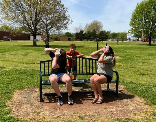 Trinity Tyson, Takoda Tyson and Bailey Dilbeck of Sulphur were traveling through the area on their way to an appointment Monday and decided to stop at Pauls Valley's Wacker Park to view the eclipse.