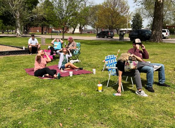 This group of family and friends from assorted nearby towns gathered at Pauls Valley's Wacker Park Monday to view the eclipse together. The group included (seated left center) Sunny Eddy, Ashley Paul, Summer Hunter and Fallon Peters.