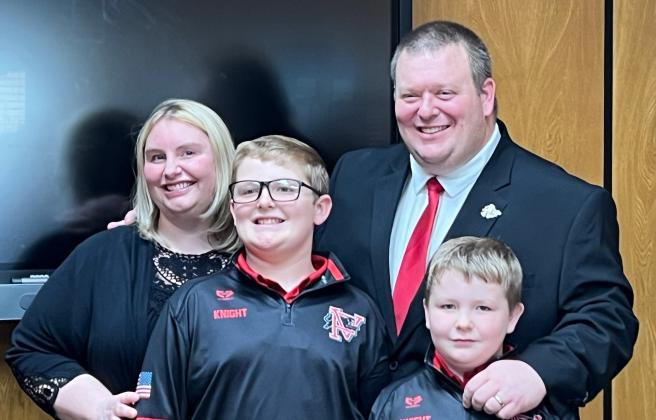 Brett Knight with his wife, Lucy, and their two sons at Thursday night's special school board meeting, where he was hired as superintendent of Pauls Valley Schools. News Star photo by Suzanne Mackey